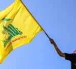 AFP A masked demonstrator waves a flag of the Lebanese Shiite movement Hezbollah during a demonstration