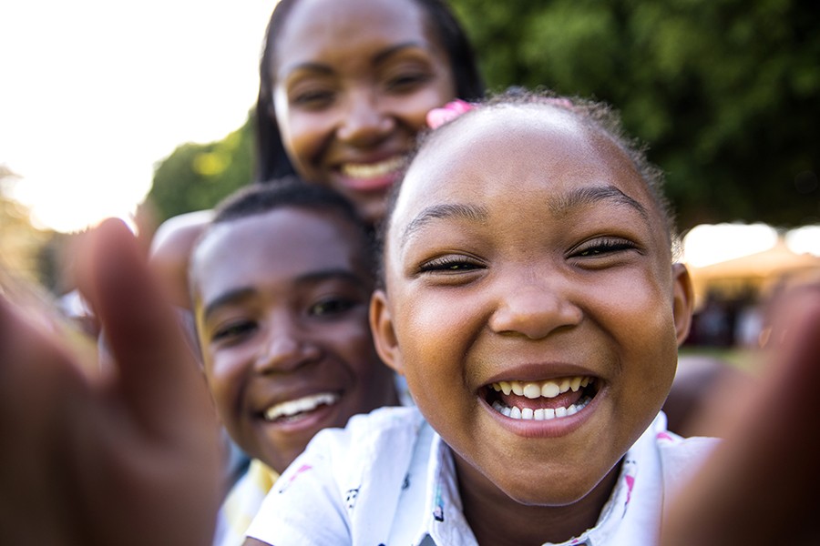 Smiling children representing diverse communities affected by sickle cell disease