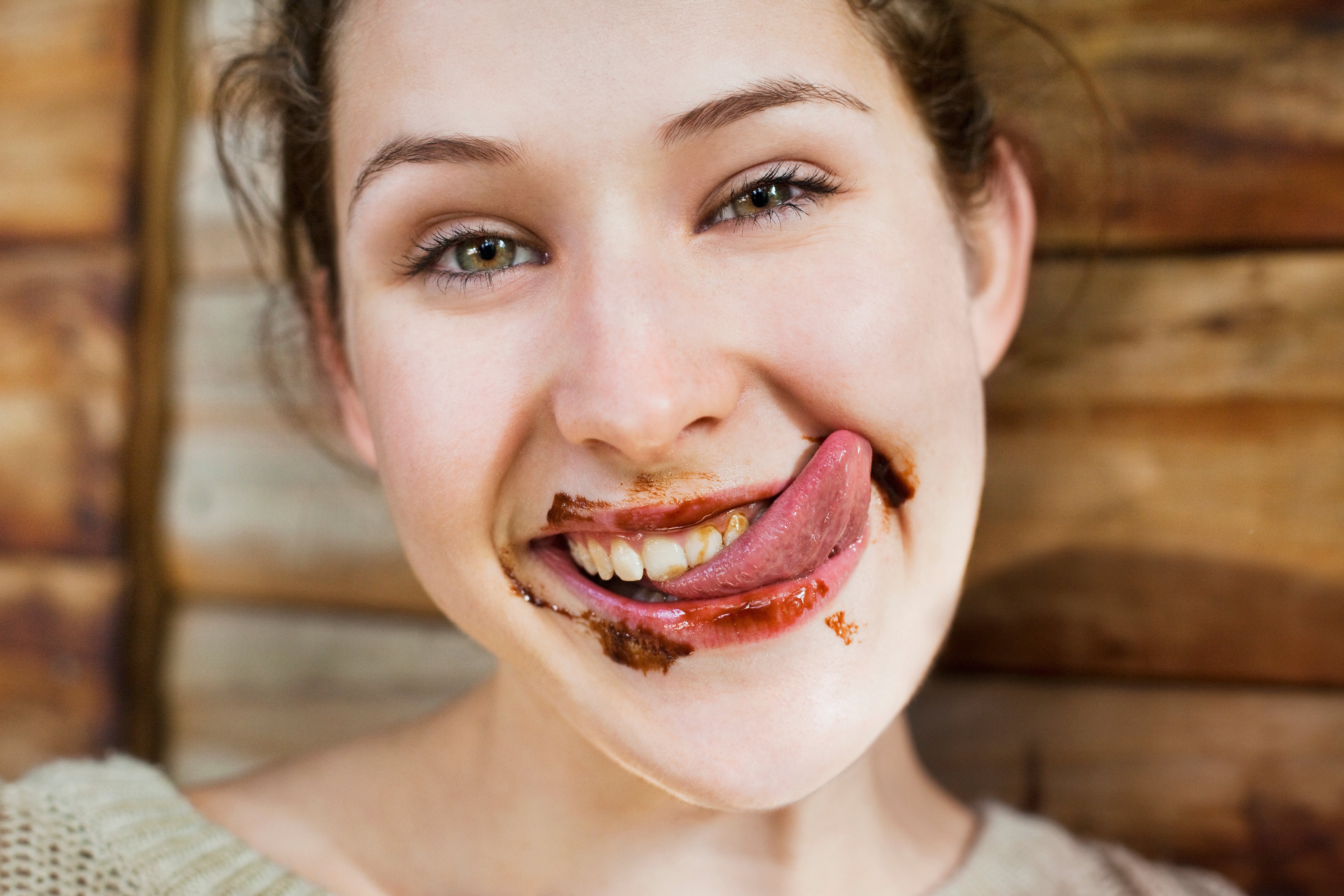 Close-up of a woman demonstrating tongue flexibility, often mistakenly associated with the myth of the tongue being the strongest muscle in the human body.