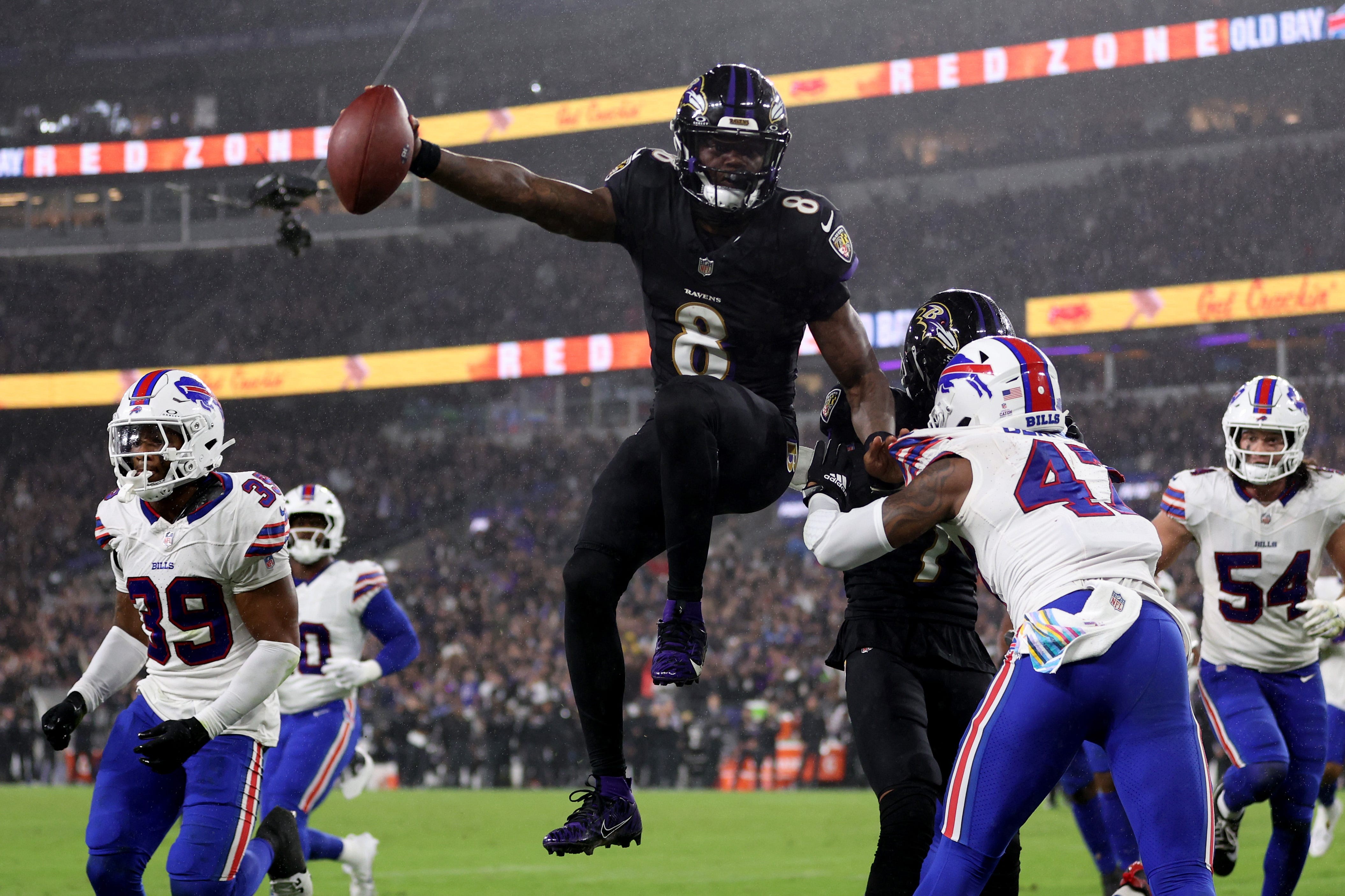 Intense NFL Monday Night Football action between two teams, showcasing a player being tackled during a game played on Monday night.