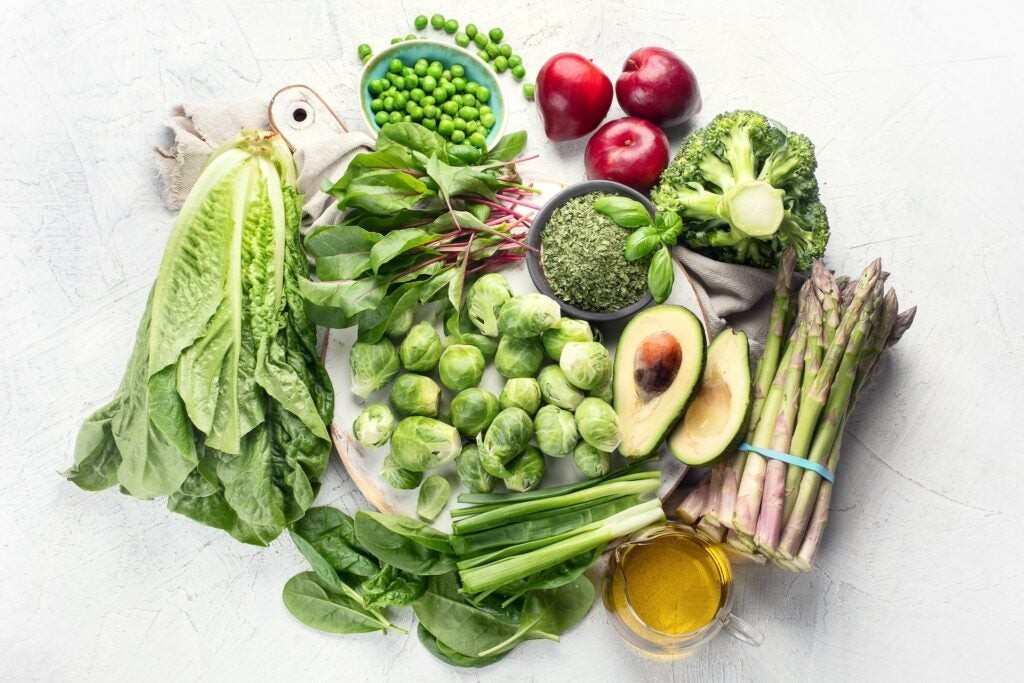 colorful foods high in vitamin k on white background