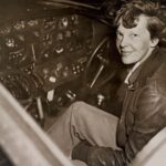 Amelia Earhart in the cockpit of her Lockheed Electra aircraft, preparing for her ill-fated world flight.