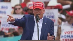 Donald Trump gesturing behind a lectern, EPA photo.