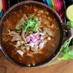 Barbacoa de borrego on a table with garnish