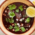 Bowl of Beef Birria Soup with toppings