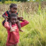 Brother showing love to sister by carrying her