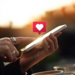 Young woman receiving notifications on her smartphone, illustrating social media networking and technology addiction.