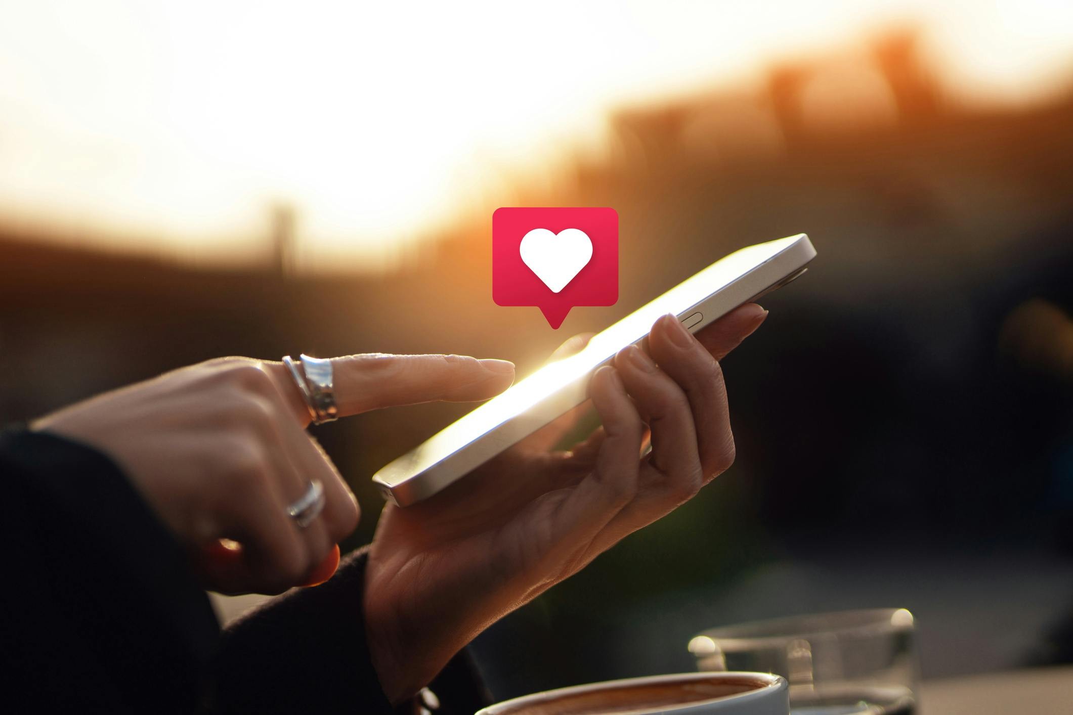 Young woman receiving notifications on her smartphone, illustrating social media networking and technology addiction.