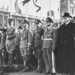 Adolf Hitler and entourage view a military parade following the annexation of Austria (the Anschluss).