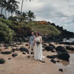 Couple holding hands in a field, representing elopement and intimate weddings