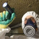 Professional asbestos surveyor wearing safety mask, emphasizing expertise in asbestos identification