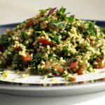 A vibrant and fresh plate of traditional Levantine Tabbouleh salad, highlighting the finely chopped parsley, mint, and tomatoes mixed with bulgur and lemon dressing.