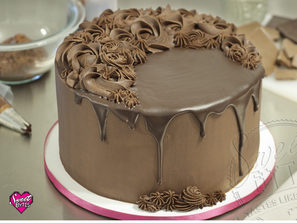 A decadent chocolate cake generously coated with smooth, dark chocolate ganache.