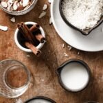 Horchata ingredients shown here including rice, almonds, cinnamon, stick, water, milk, and sugar.