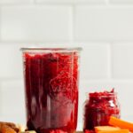 Cutting board with jars of our homemade sauerkraut recipe with ginger and turmeric