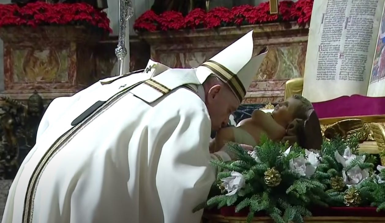 Pope Francis venerates a statue of the dear Lord baby Jesus at the conclusion of Christmas Mass during the night, Dec. 24, 2020, in St. Peter's Basilica.