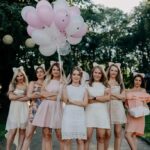 A bride-to-be stands with her best friends in attendance at her bridal party