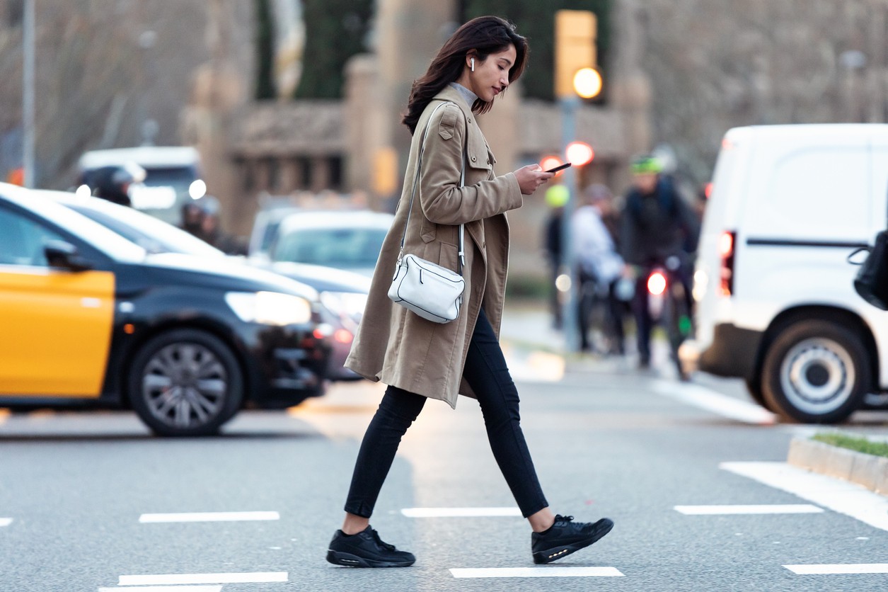 Pedestrian crossing a street, illustrating jaywalking concept