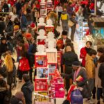 Massive crowds of shoppers fill the streets outside Macy's Herald Square in New York City on Black Friday, the day after Thanksgiving, highlighting the Black Friday shopping frenzy.