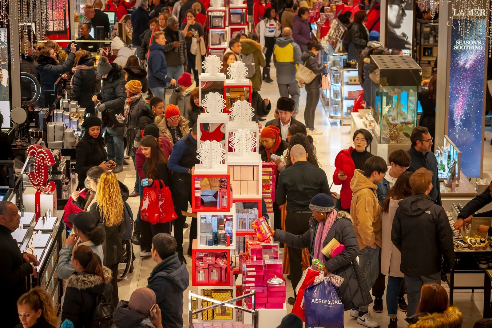 Massive crowds of shoppers fill the streets outside Macy's Herald Square in New York City on Black Friday, the day after Thanksgiving, highlighting the Black Friday shopping frenzy.