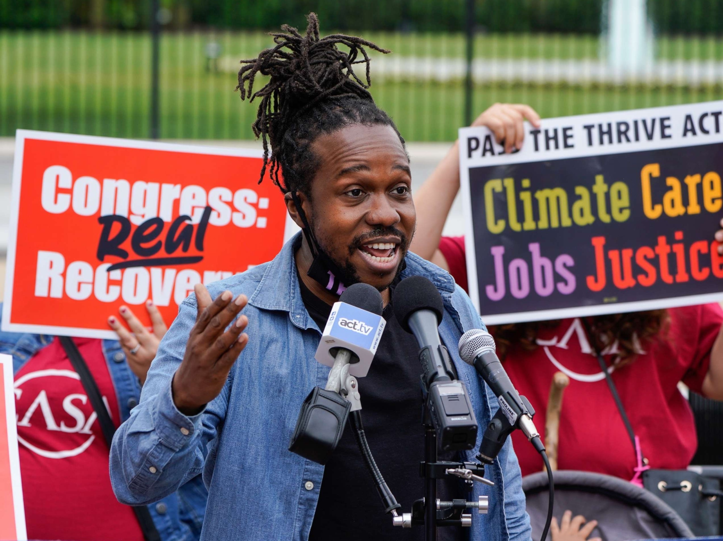 Activist Maurice Mitchell speaking at a demonstration in Washington, D.C., advocating for climate action, healthcare, jobs, and social justice.