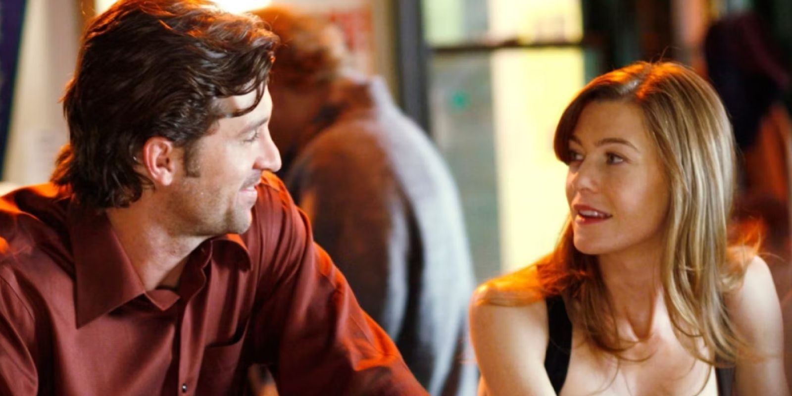 Meredith and Derek sharing a happy moment in Grey's Anatomy, illustrating their central relationship in the series.