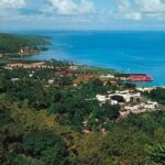 Aerial view of Port Antonio coastline in Jamaica showcasing the clear turquoise waters and lush greenery.