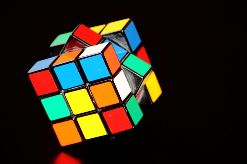 Person solving a Rubik's Cube, representing problem-solving and cognitive skills