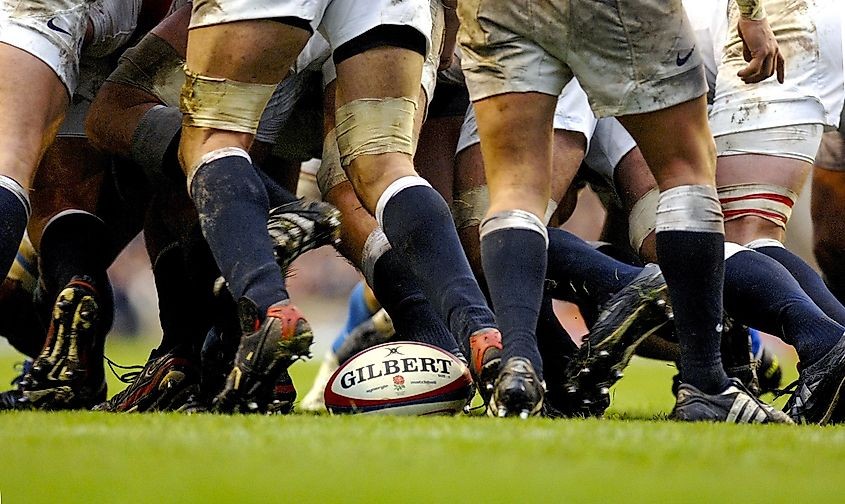 Rugby players engaged in a scrum during a match