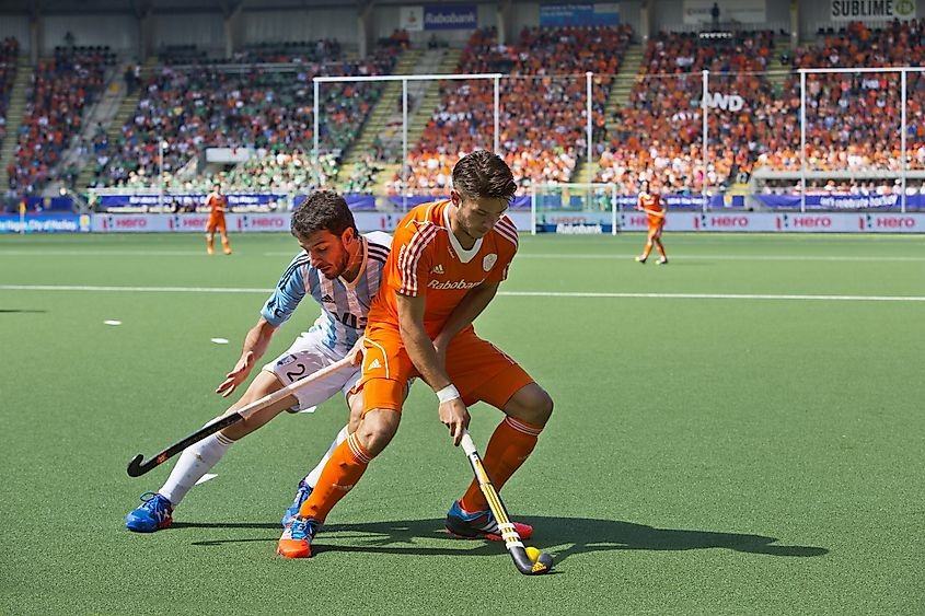 Hockey players competing for the ball during a field hockey game