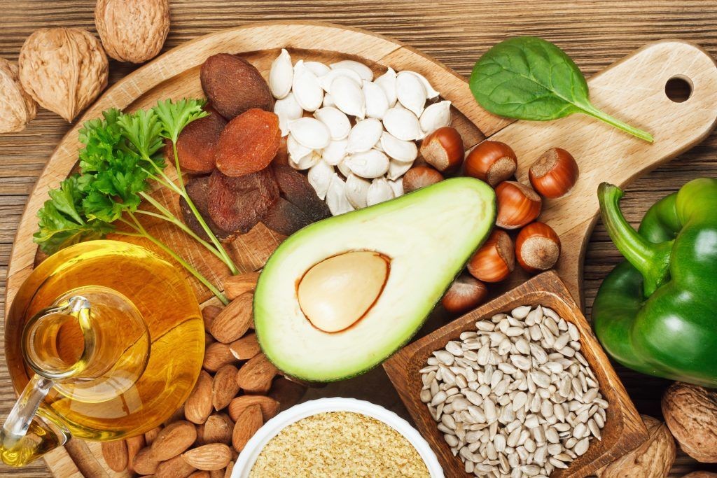 Foods rich in vitamin E such as wheat germ oil, dried wheat germ, dried apricots, hazelnuts, almonds, parsley leaves, avocado, walnuts, pumpkin seeds, sunflower seeds, spinach and bell pepper