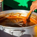 Close-up of rich mole sauce in a bowl, showcasing its thick texture and deep color