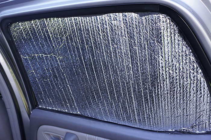 Reflectix car window insulator with silver side facing inwards to reflect heat back into the car, improving car comfort in cold weather. DIY car insulation using Reflectix.