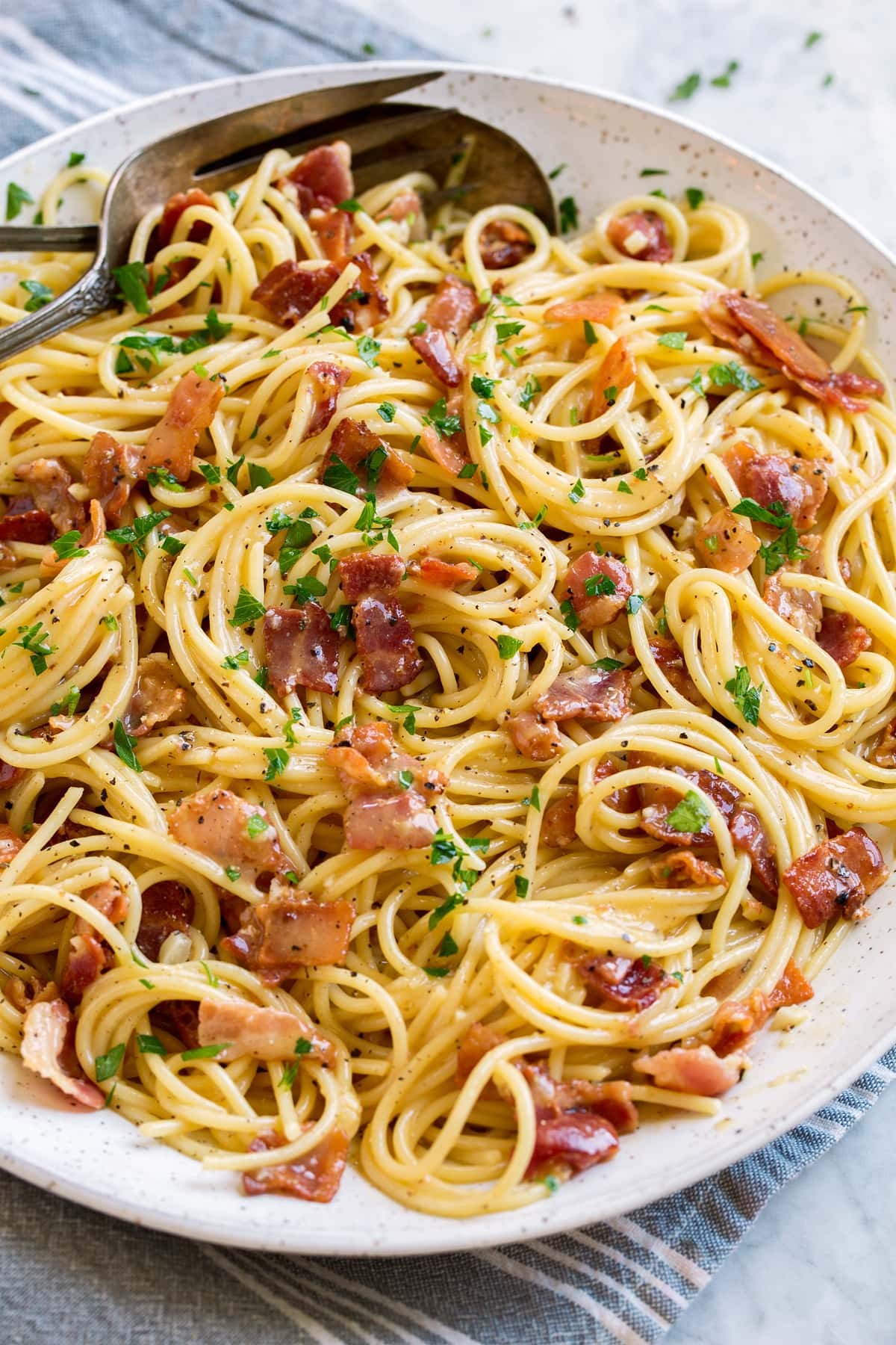 Pasta carbonara shown in a large white serving bowl.