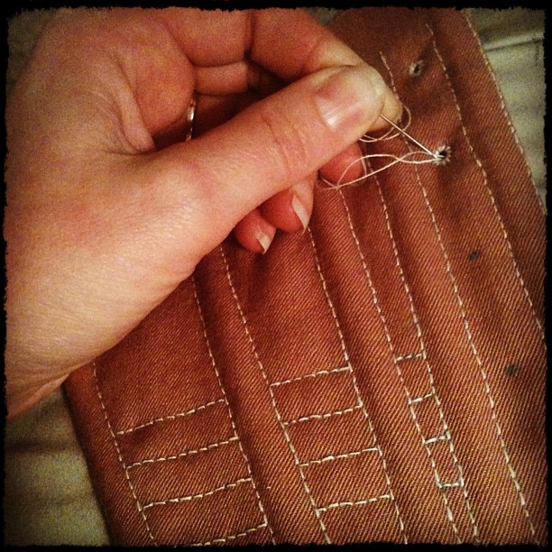 Close-up of hand-sewn stitches on 1790s stays, showcasing detailed craftsmanship and meditative nature of hand sewing.