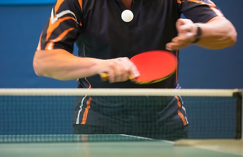 A table tennis player serving the ball