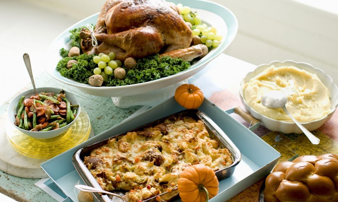 A Thanksgiving feast showcasing classic dishes like turkey, stuffing, mashed potatoes, gravy, carrots, and green beans, embodying the spirit of the holiday.