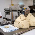 Fresh masa dough for homemade corn tortillas displayed at a market in Cozumel, Mexico.