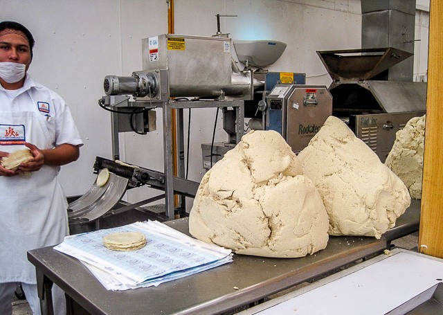 Fresh masa dough for homemade corn tortillas displayed at a market in Cozumel, Mexico.