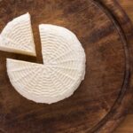 Homemade Paneer on a wooden board.