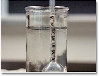 Hydrometer used to measure the density of a clear liquid, demonstrating a scientific instrument for density measurement