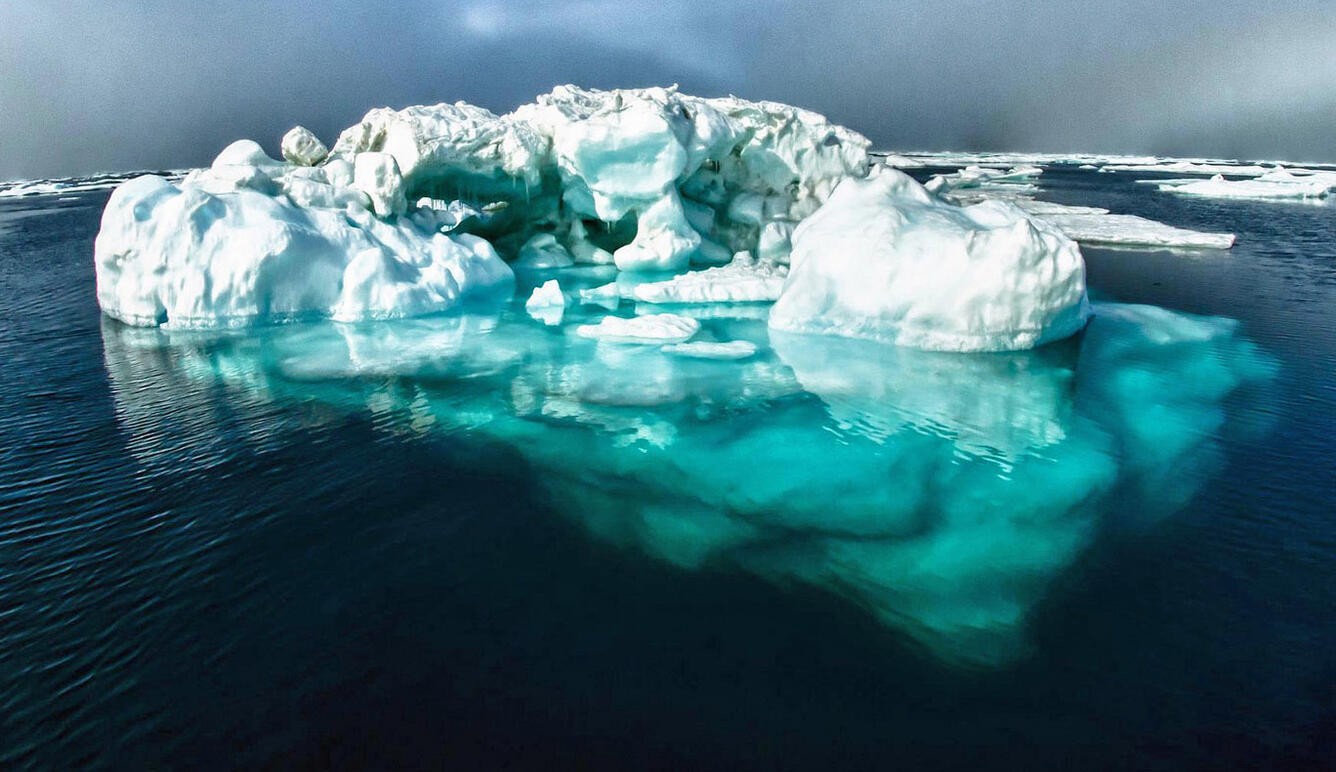 Large iceberg floating in the ocean, illustrating that most of its mass is below the waterline