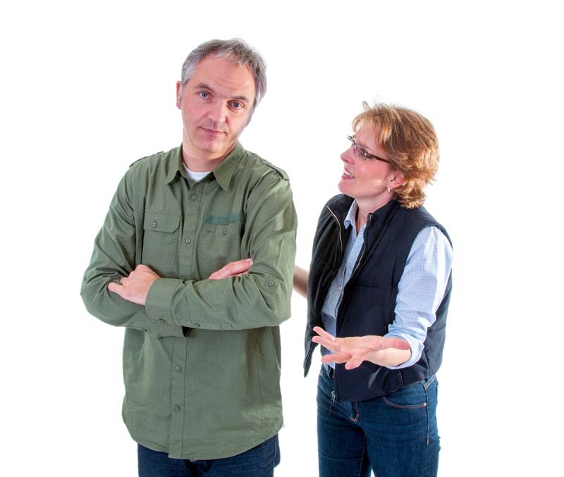 One partner looking away while the other talks to them, illustrating the lack of engagement that can occur in a relationship with a nonchalant partner