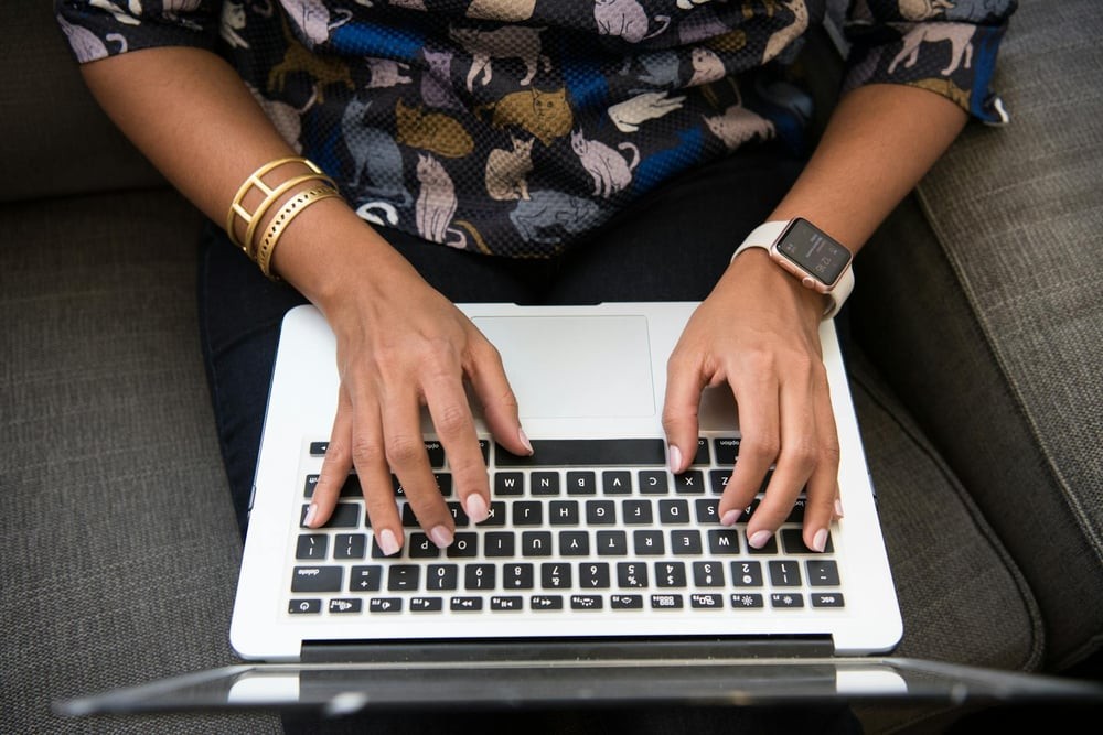 Hands on a laptop keyboard.