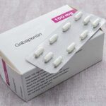 Photo of generic gabapentin pills and blister pack resting on top