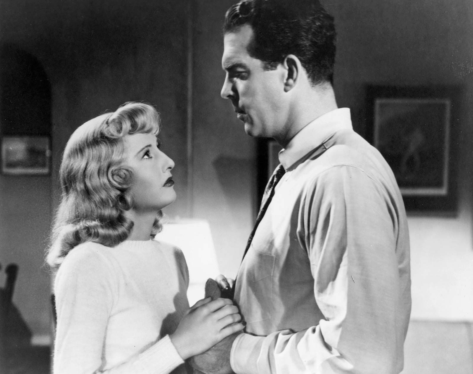 High-contrast lighting in a film noir scene to enhance the dramatic effect and sense of mystery