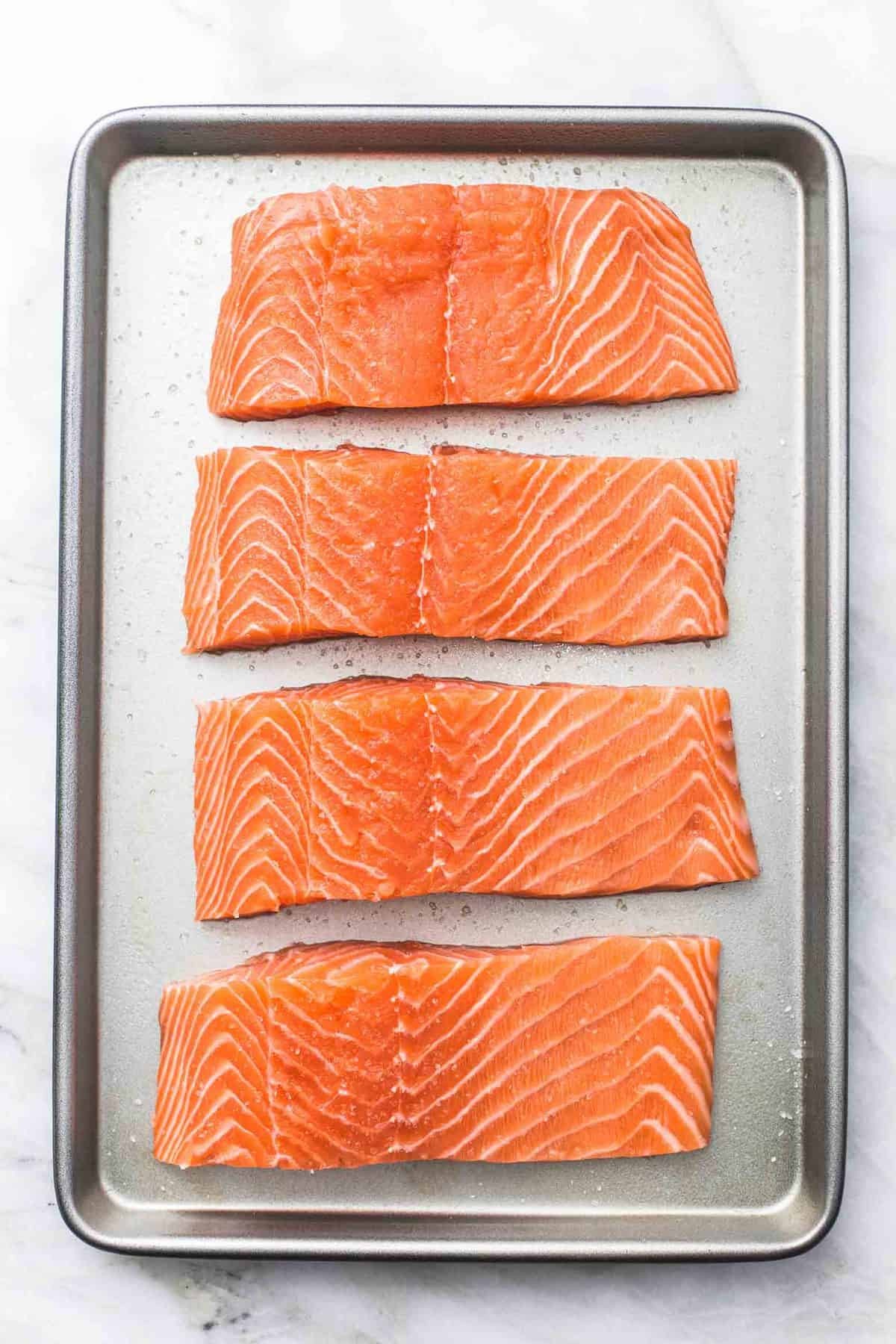 Fresh salmon fillets, ready to be seasoned and cooked for a healthy meal.