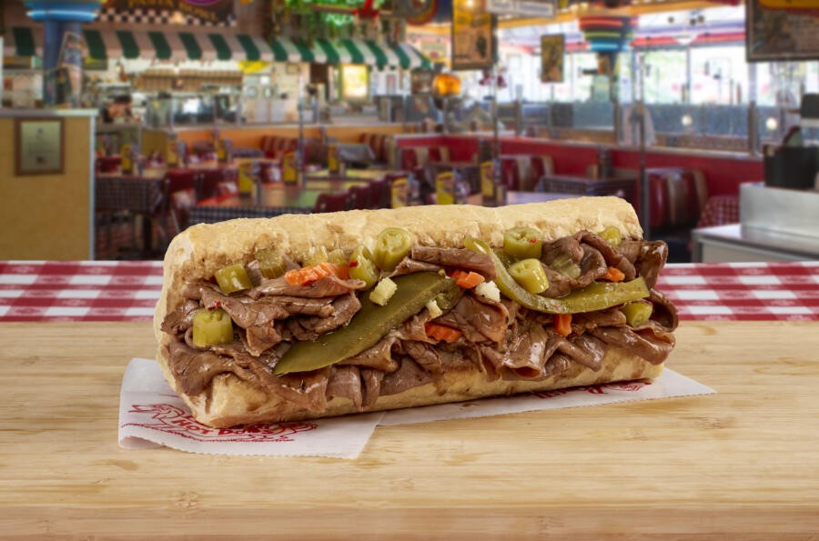An Italian beef sandwich, showcasing thinly sliced beef and giardiniera