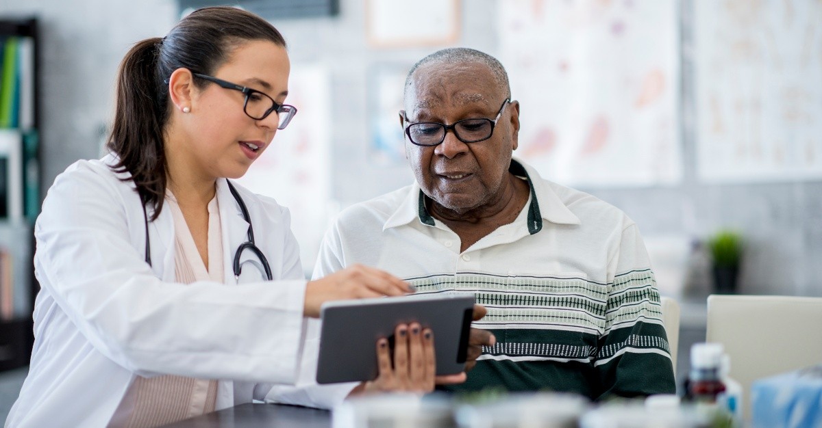 A medical professional takes a patient's blood pressure during a biometric screening, a vital step in preventative health.