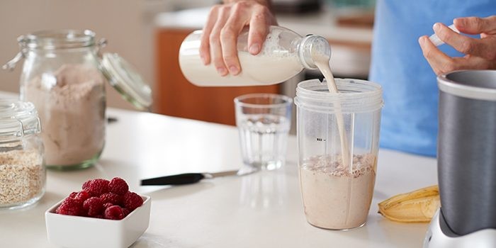 Man preparing a healthy meal with various protein sources